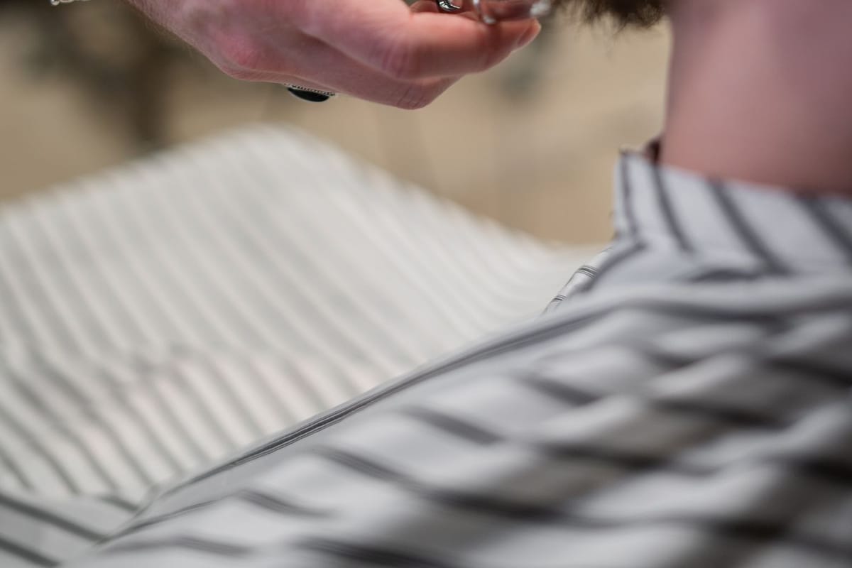 A barber’s clippers, scissors, comb and cut-throat razor laid out ready