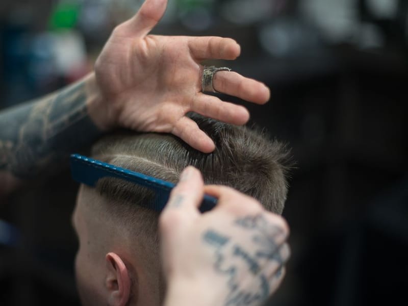 Barber giving a polished, smart cut to a professional client from Gidea Park