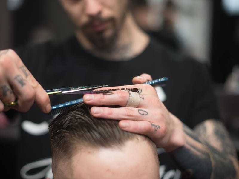 Barber shaping a beard for a client who has come in from Rainham