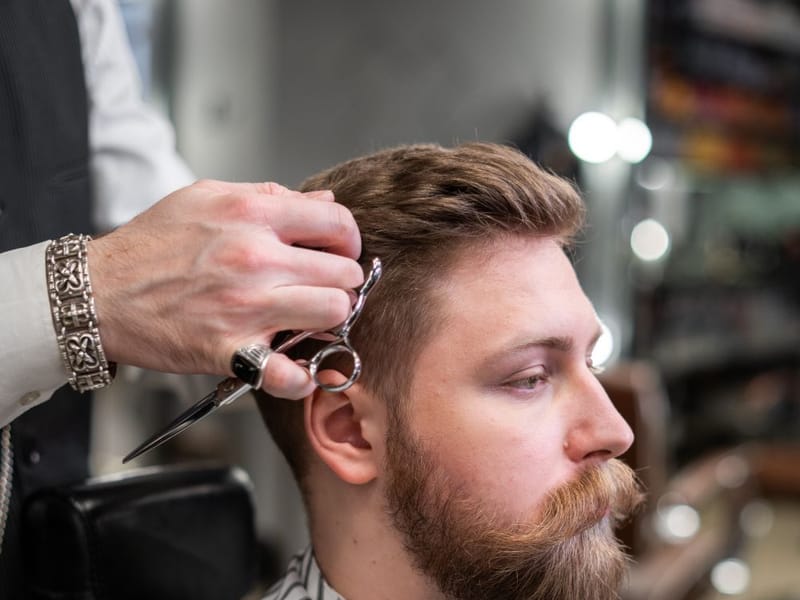 A textured fringe haircut with a clean tapered finish at the sides