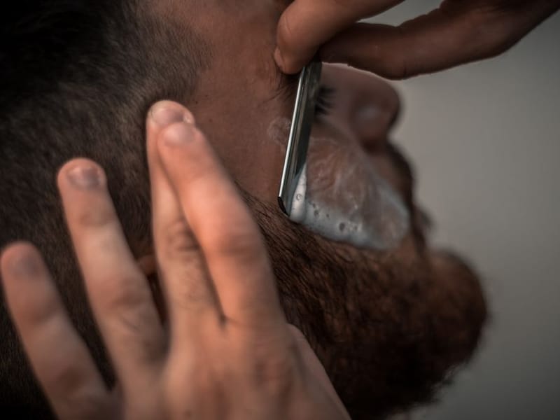 A traditional hot-towel cut-throat wet shave in progress