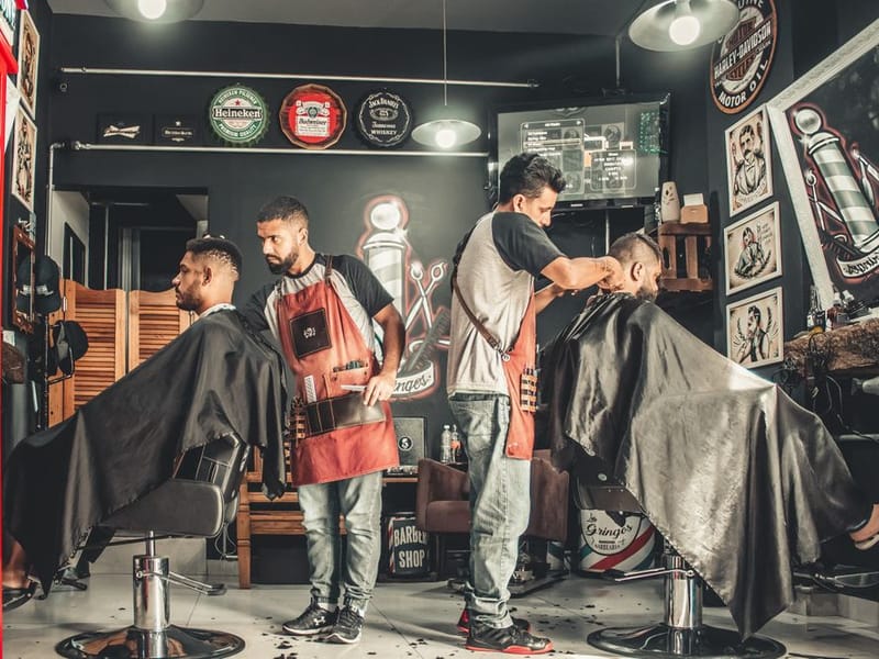 Barber blending a sharp skin fade into a client’s hair with clippers